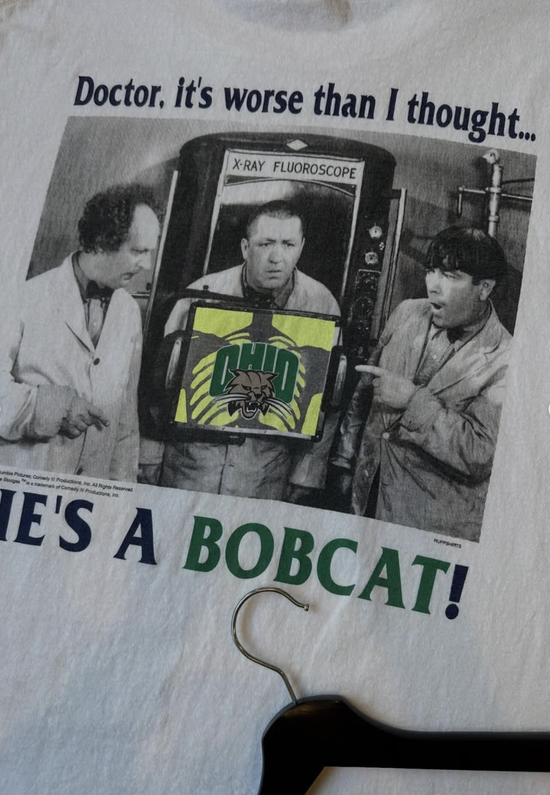 Vintage white tee featuring the Three Stooges and the phrase 'Doctor, it's worse than I thought. He's a Bobcat!' in Ohio University colors.